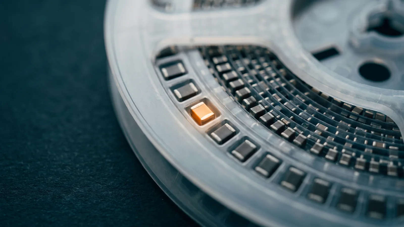 Surface-mount passive components on a tape-and-reel with one highlighted
