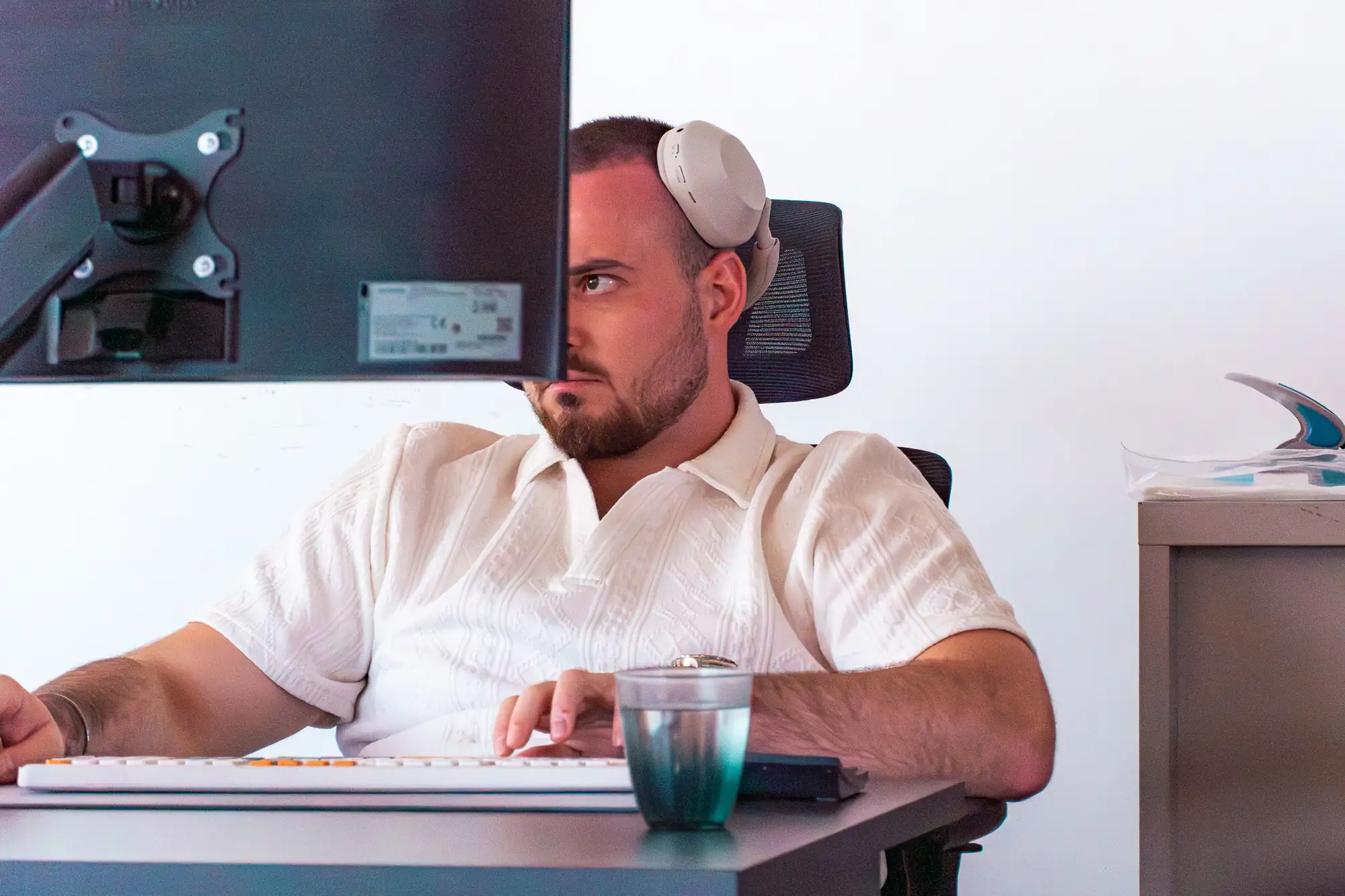 A Harness Code specialist at his desk, working a parts enquiry