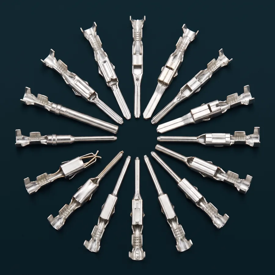 Crimp terminals fanned in a circle: tin-plated receptacles, blade tabs and pin contacts